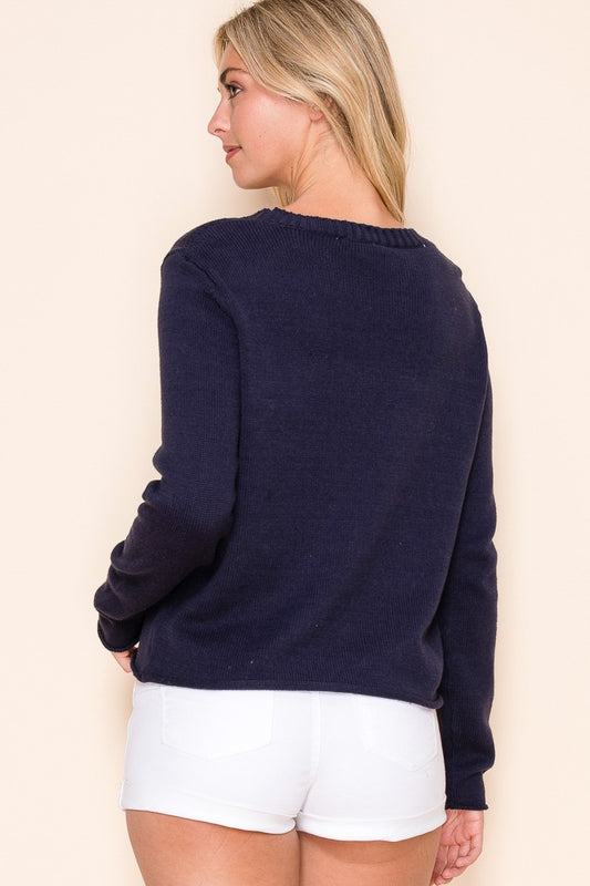 A breezy nautical-inspired sweater featuring an anchor motif, perfect for beach days or boat rides.

