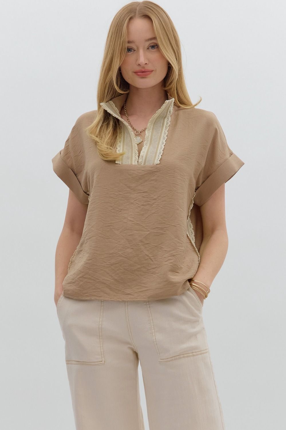 A breezy short sleeve pullover top with multicolor crochet trim and roll-up banded sleeves.

