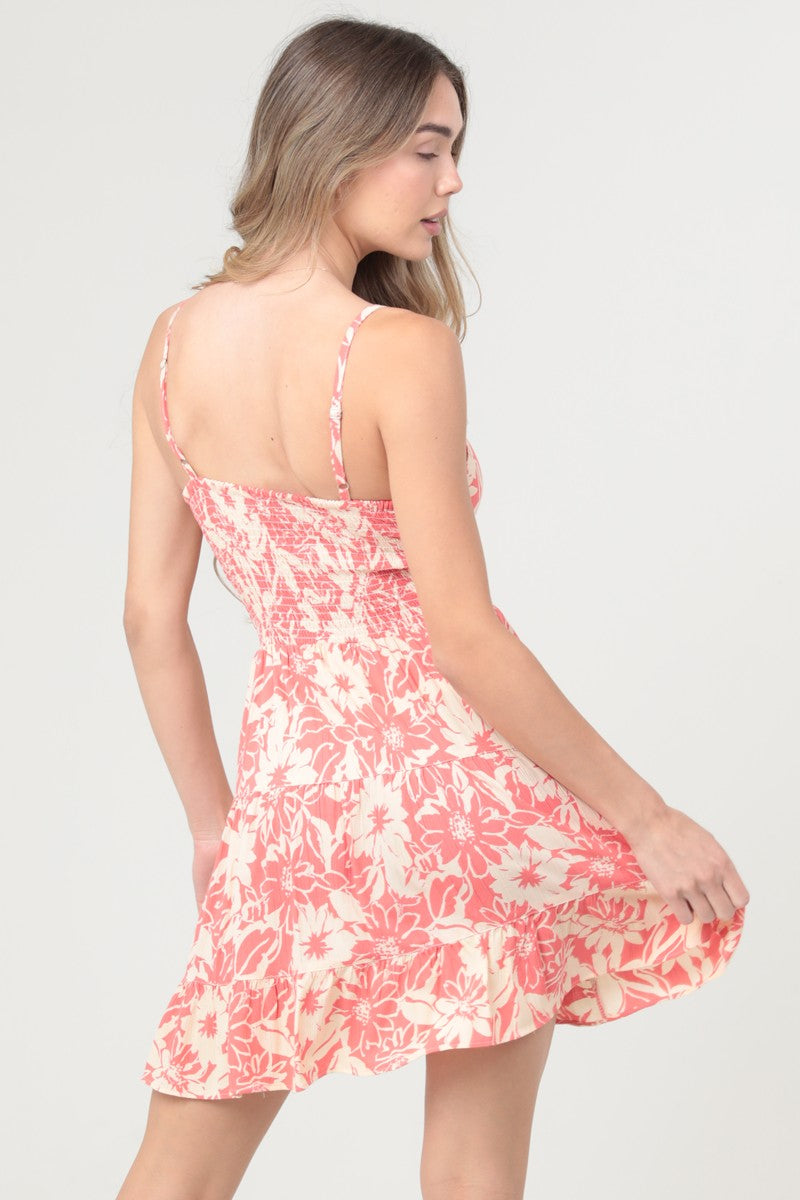 A breezy sundress featuring a twist-front bodice, flattering cut-out detail, and timeless V-neckline.