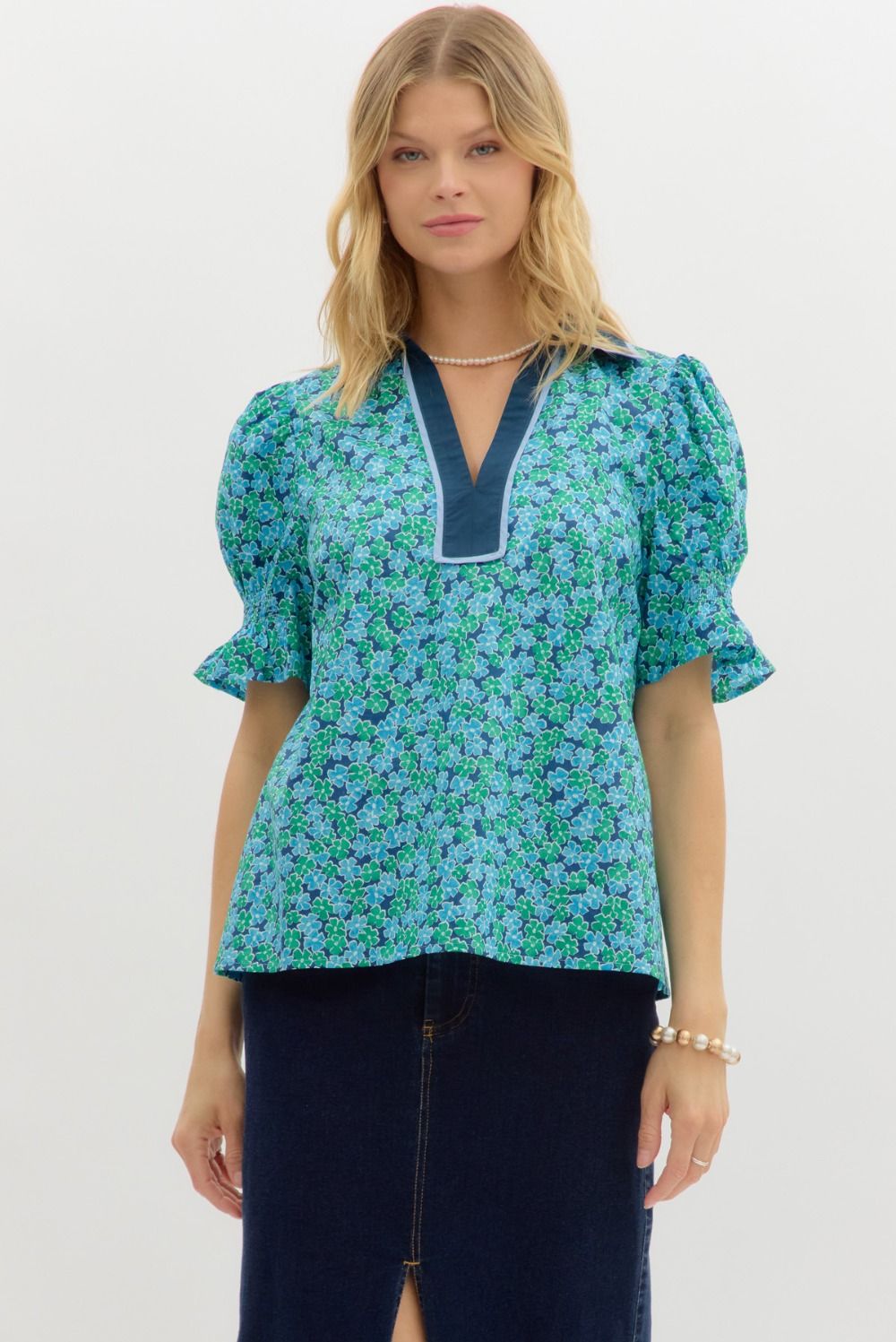 A charming floral pullover top with puff sleeves, contrast binding, and a smocked detail for comfort.

