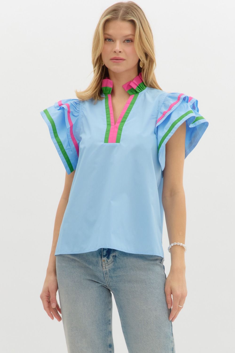 A charming flutter sleeve top with multicolor ruffle accents that add a playful, polished touch.