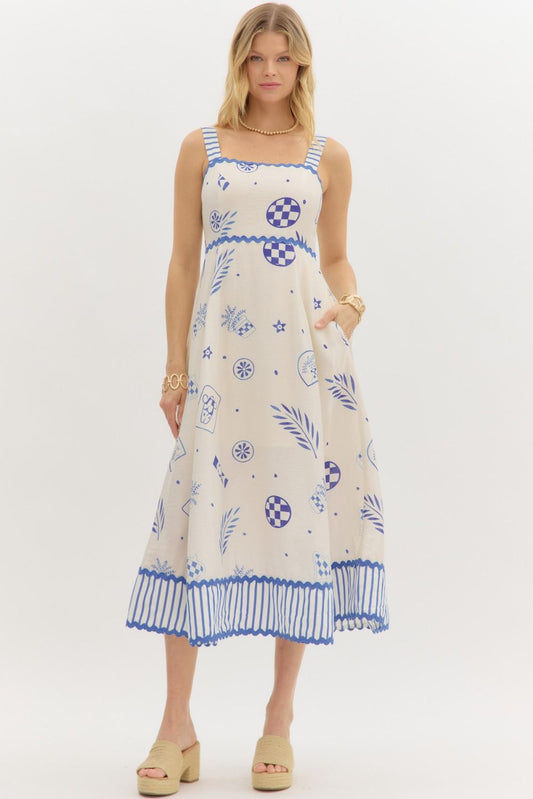 A chic multi-print midi dress with adjustable striped straps and a ricrac-accented hem for a playful finish.