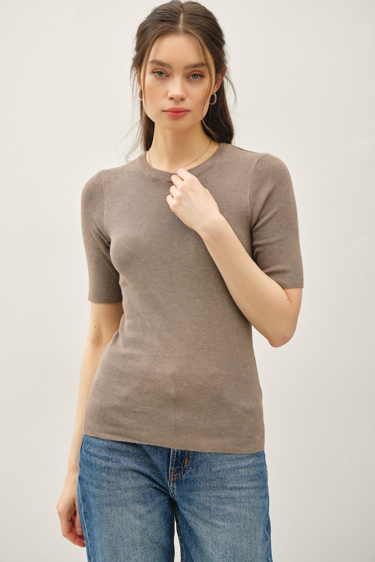 A classic ribbed knit top with a fitted silhouette and crew neckline—your go-to for sleek, effortless layering.