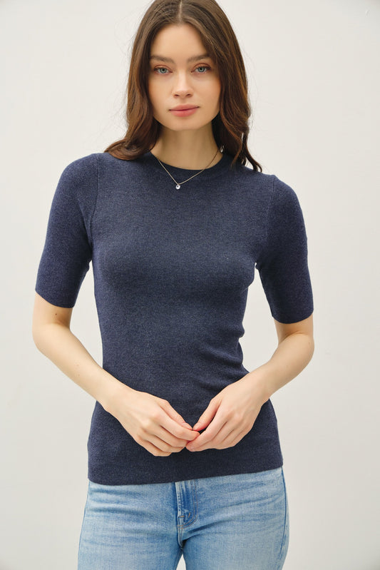 A classic ribbed knit top with a fitted silhouette and crew neckline—your go-to for sleek, effortless layering.