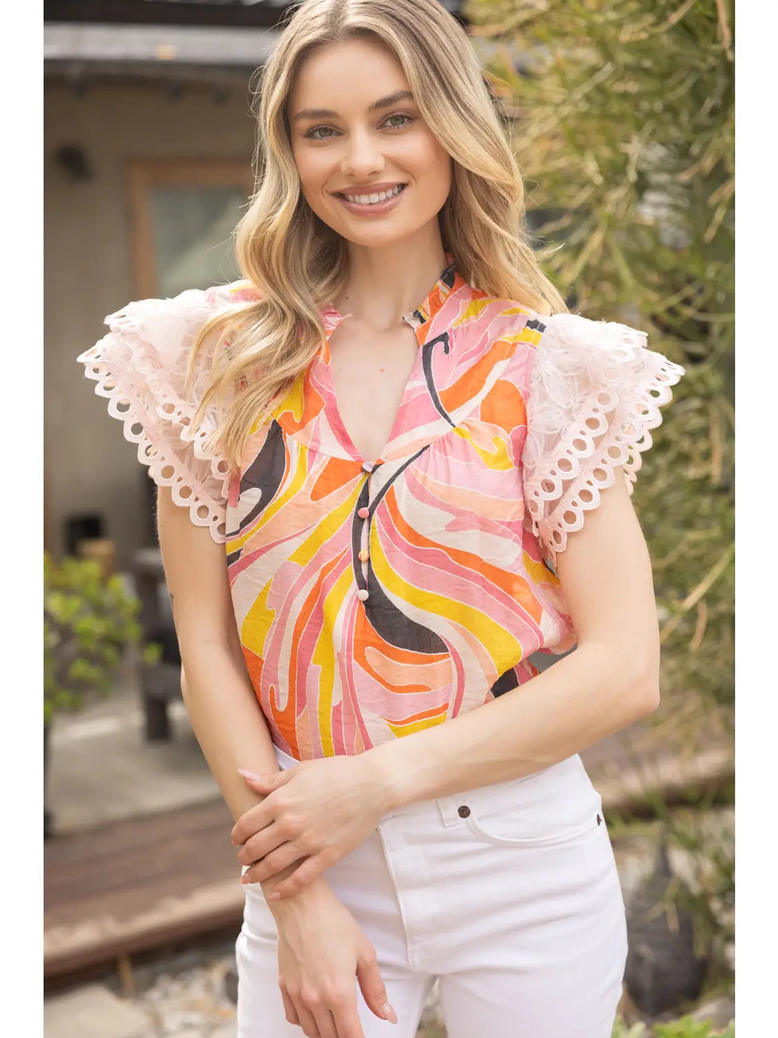 A delicate floral mesh top with ruffled details and layered sleeves for a soft, romantic statement.