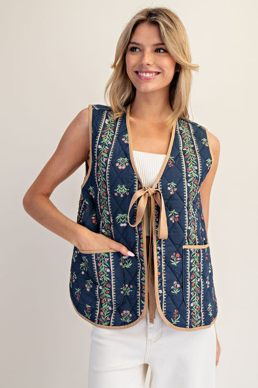 A floral-quilted cotton vest with pink contrast trim and a sweet front-tie finish.