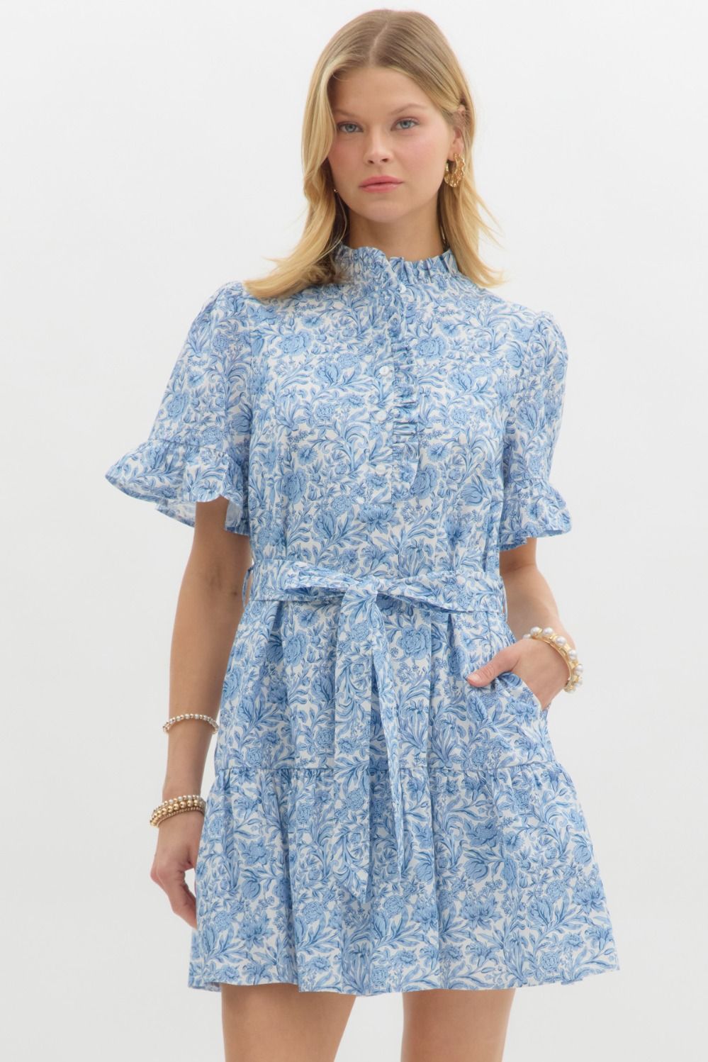 A floral mini dress with ruffle accents and a belted waist for a sweet, feminine silhouette.