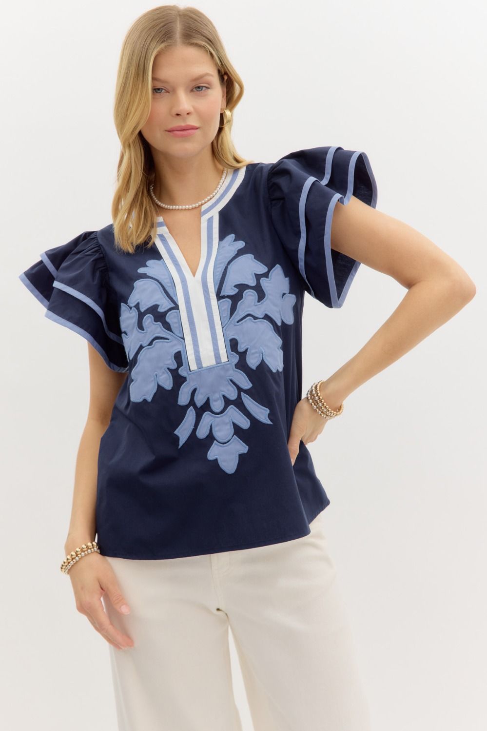 A flutter sleeve V-neck top with vibrant multicolor embroidery and appliqué detailing.