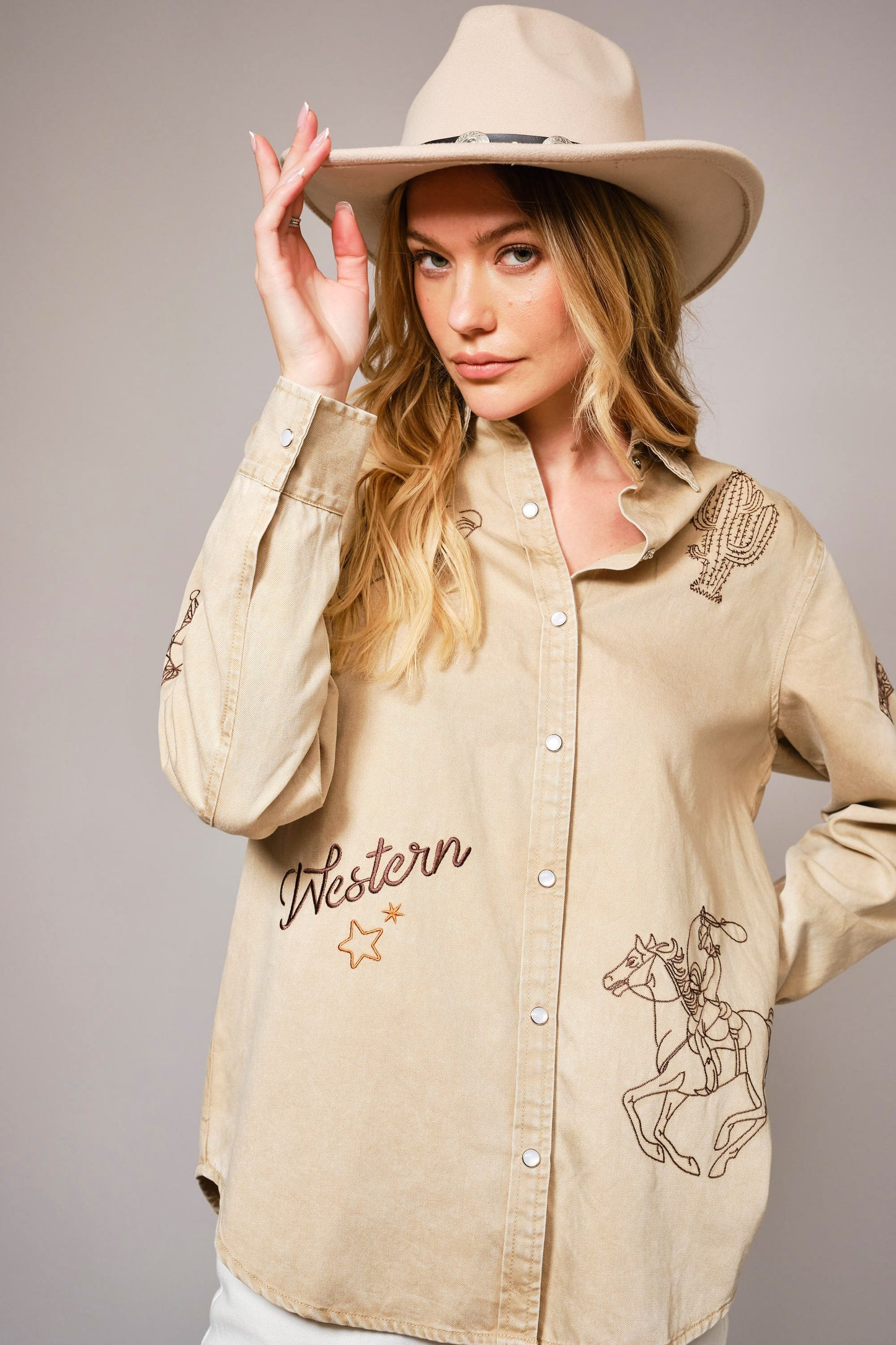 A garment-washed chambray shirt with western embroidery and classic snap buttons.
