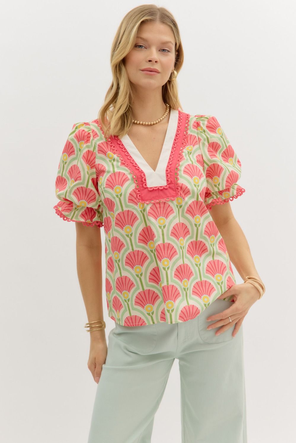 A lightweight abstract print top with puff sleeves and delicate scallop lace accents.

