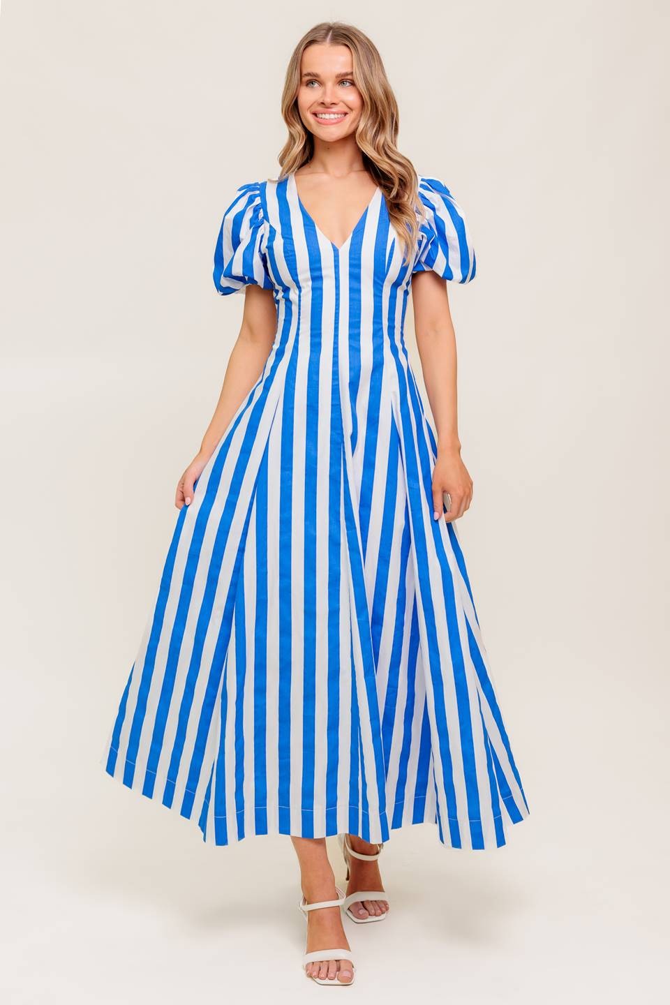 A printed cotton midi dress with puff sleeves, a V neckline, and a classic circle skirt.

