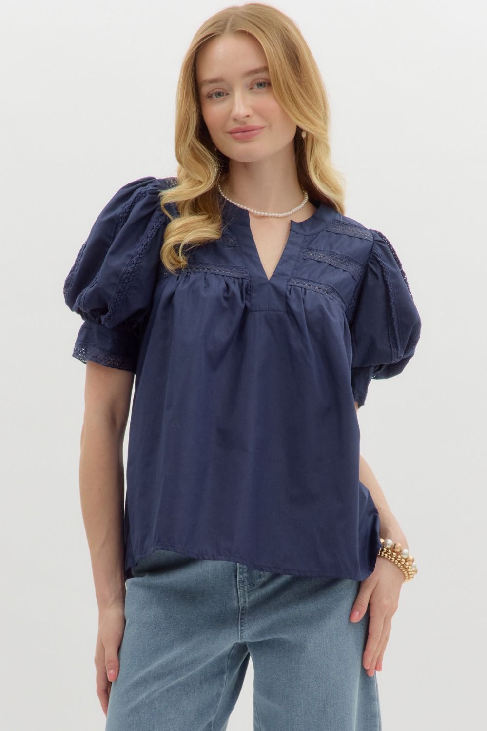 A romantic V-neck puff sleeve top with delicate lace insets and a soft, lightweight feel.