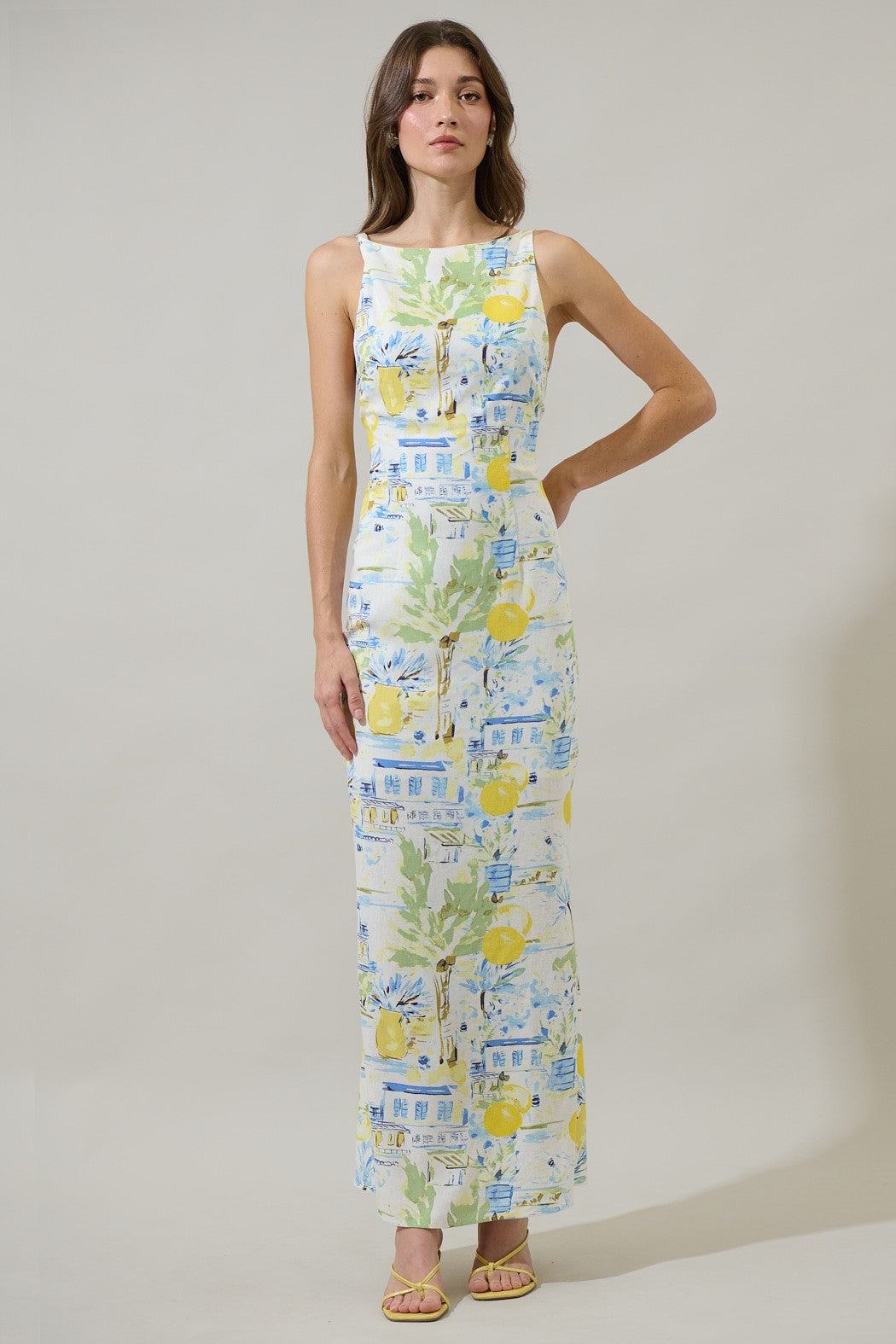  A sleek, open-back midi dress with a relaxed fit and subtle slit—made for effortlessly elevated style.
