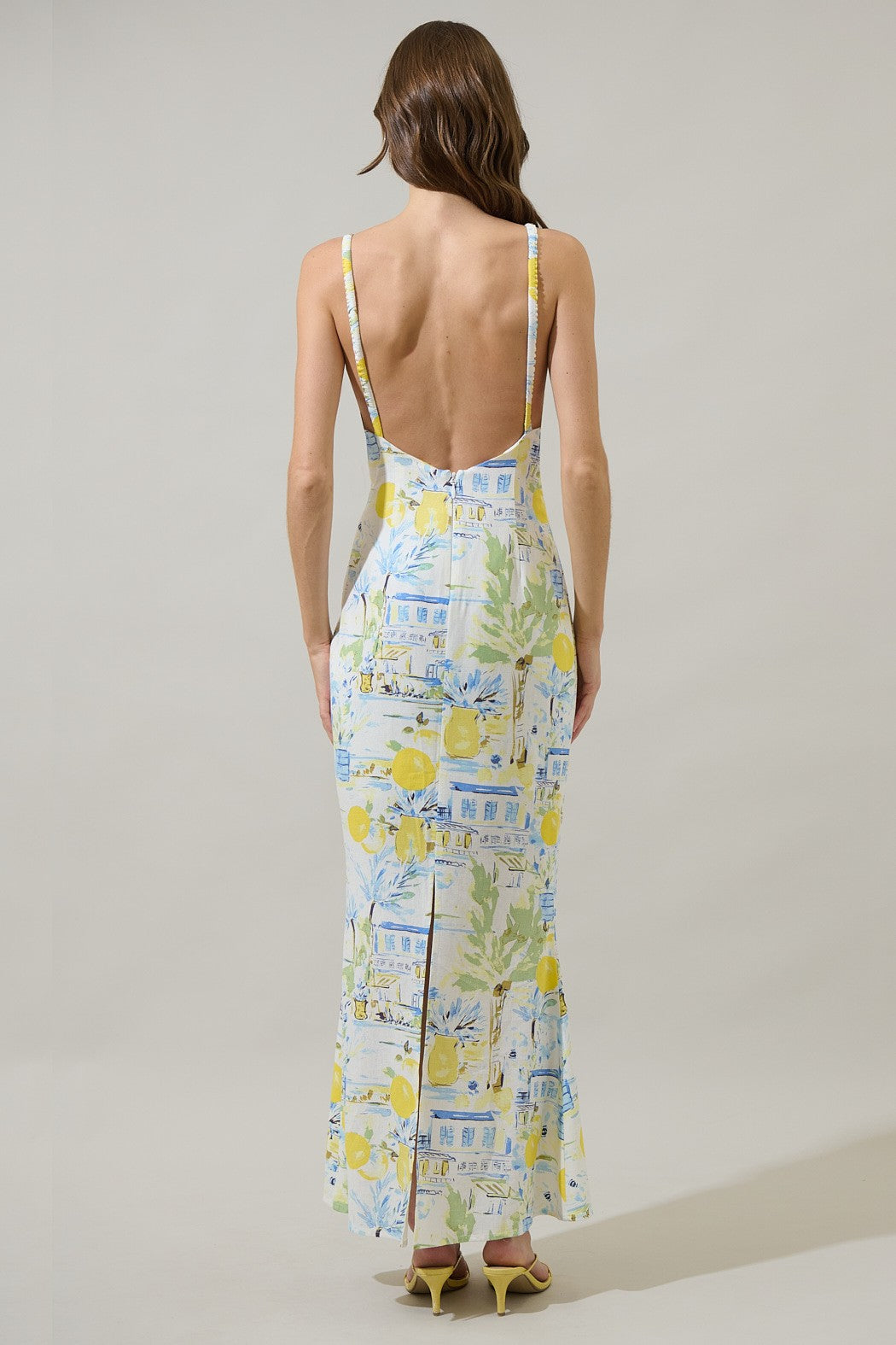  A sleek, open-back midi dress with a relaxed fit and subtle slit—made for effortlessly elevated style.
