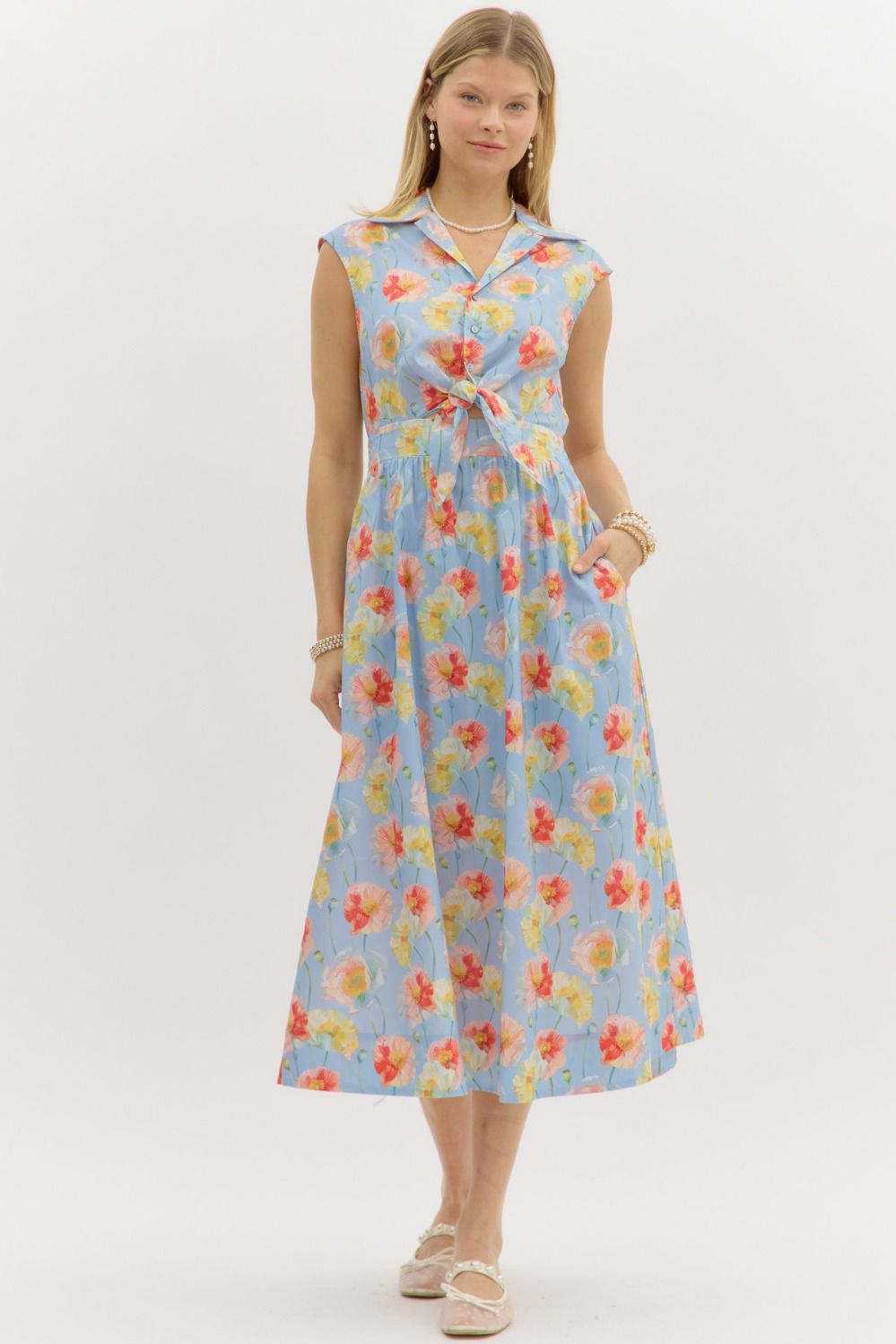 A sleeveless floral midi dress with a knotted front detail and smocked back for all-day comfort.

