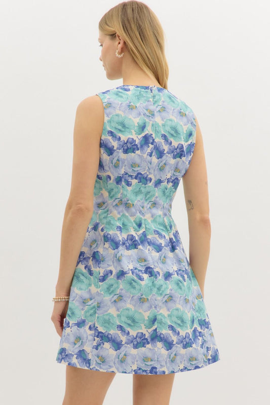 A sleeveless floral mini dress with crisp pleats and a flattering fit.
