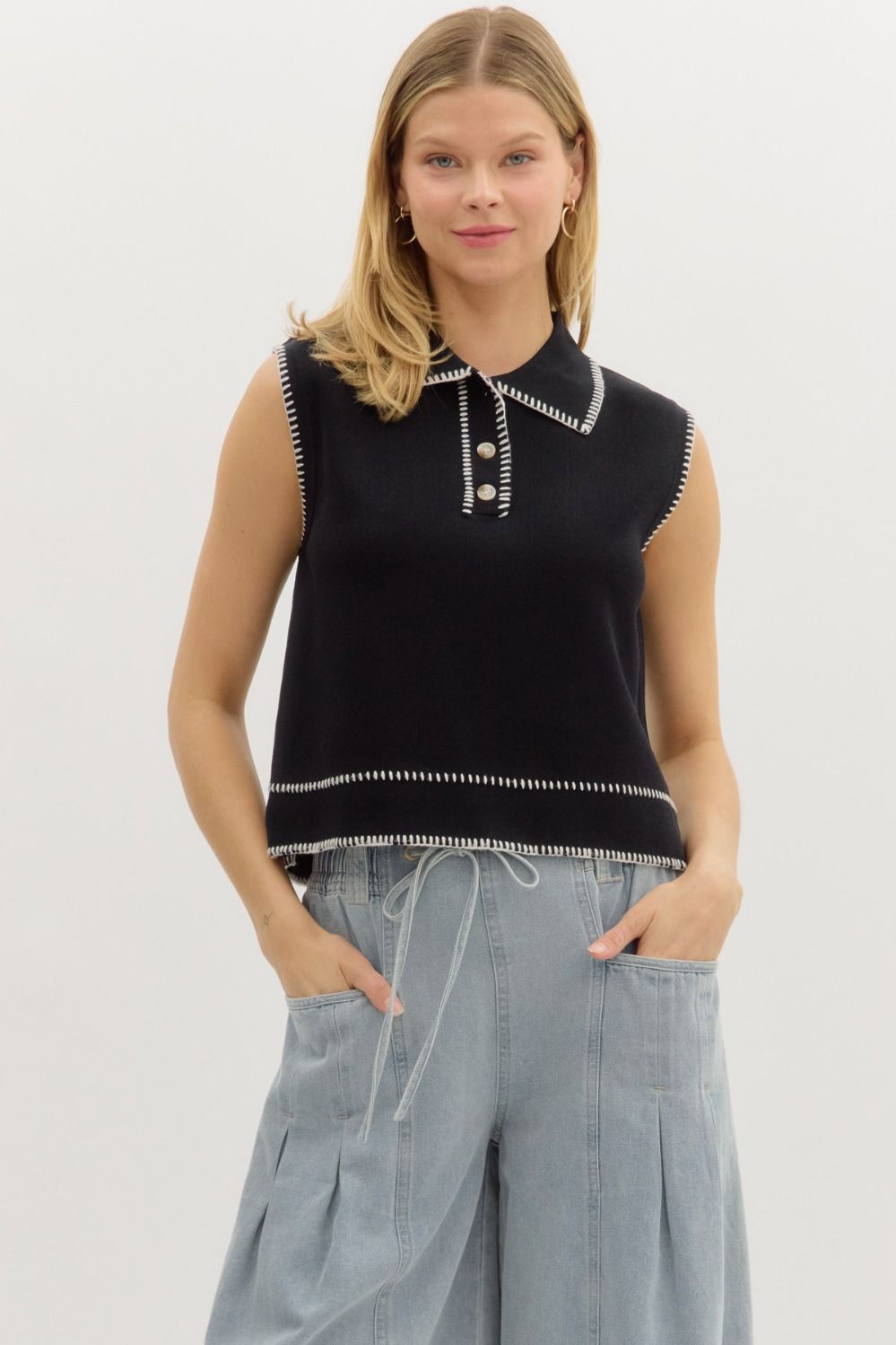 A sleeveless sweater knit top with a button front and unique blanket stitch collar—cozy meets polished in this elevated essential.