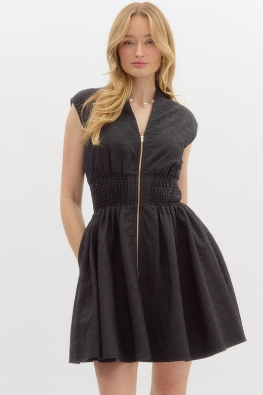A sophisticated sleeveless mini dress with a floral diamond pattern, smocked waist, and functional side pockets for effortless elegance.