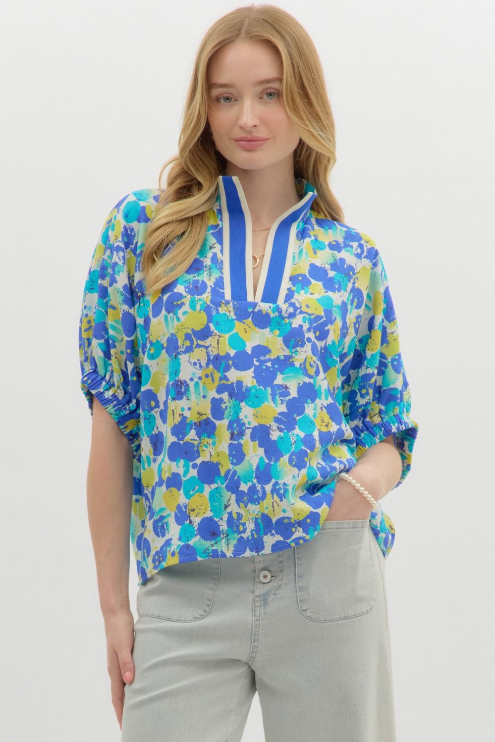 A vibrant, easygoing top with dolman sleeves and a colorful abstract print.