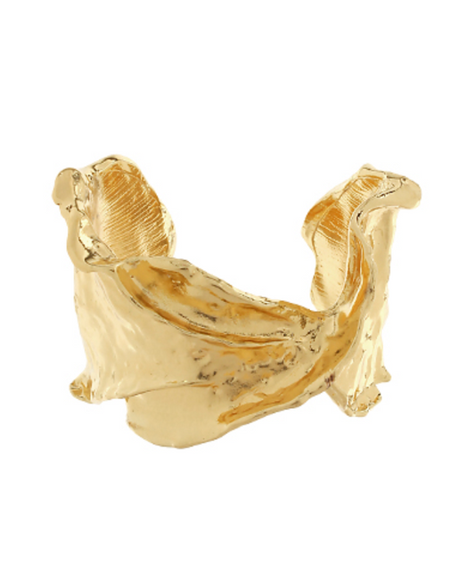 Aurora Wave Cuff Bracelet in sculpted gold-tone metal with flowing, asymmetrical design on white background.