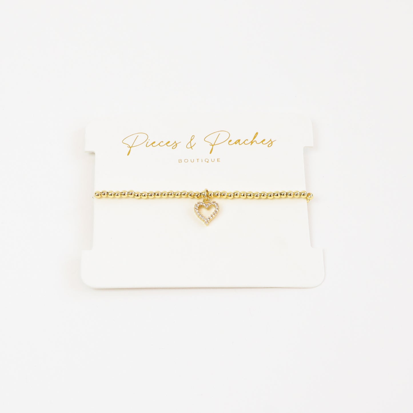 A chic and meaningful 14K gold-plated bracelet with 3mm beads and a classic heart charm, symbolizing love and connection.