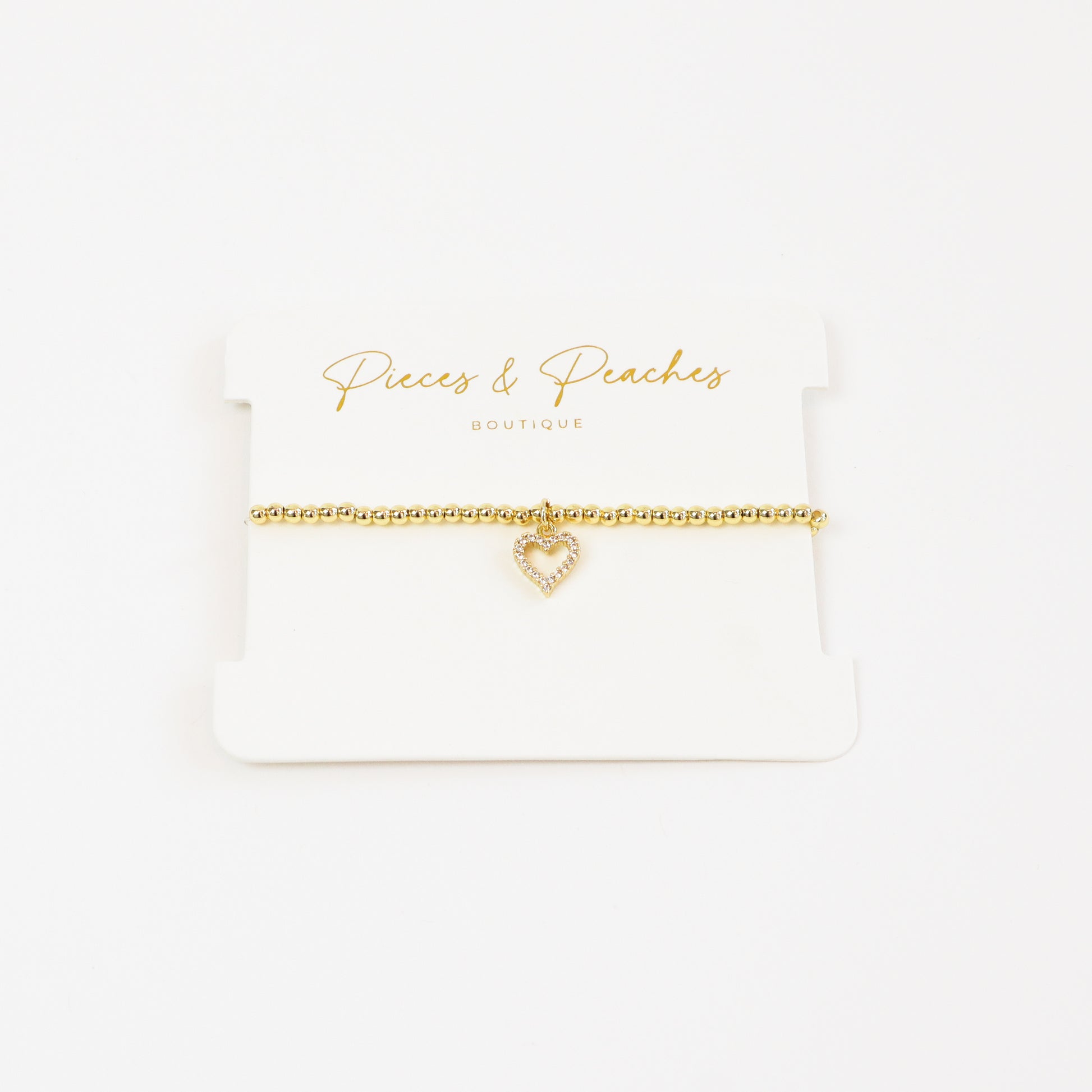 A chic and meaningful 14K gold-plated bracelet with 3mm beads and a classic heart charm, symbolizing love and connection.