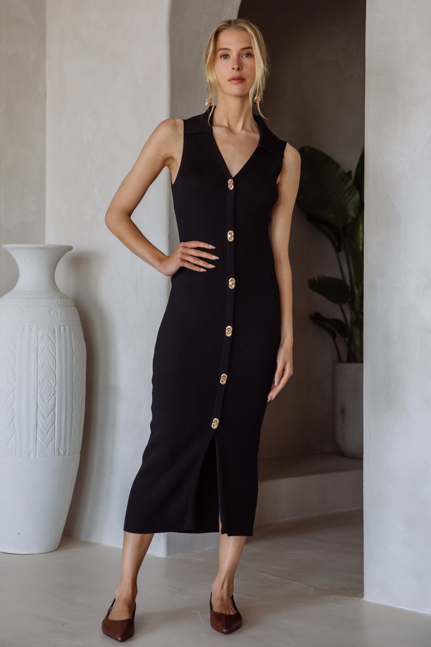 The Leona Dress blends timeless elegance with modern sophistication. Designed with a sleeveless cut and midi length, it features luxe gold twist lock buttons down the front for an eye-catching detail. Its soft, body-skimming knit drapes beautifully, making it perfect for dinner dates, work events, or polished weekend wear.

