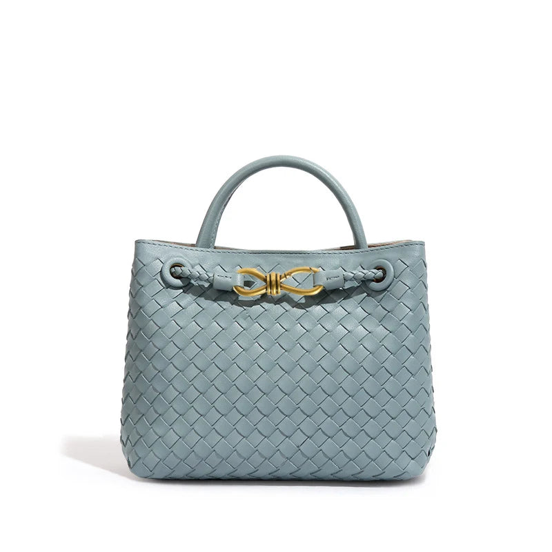 Elegant woven leather tote bag with gold-tone bow hardware and structured handles