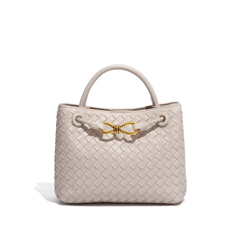 Elegant woven leather tote bag with gold-tone bow hardware and structured handles