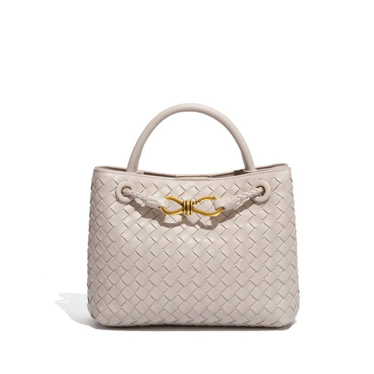 Elegant woven leather tote bag with gold-tone bow hardware and structured handles