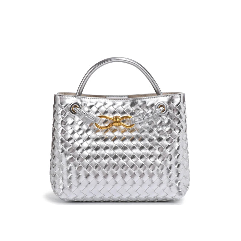 Elegant woven leather tote bag with gold-tone bow hardware and structured handles