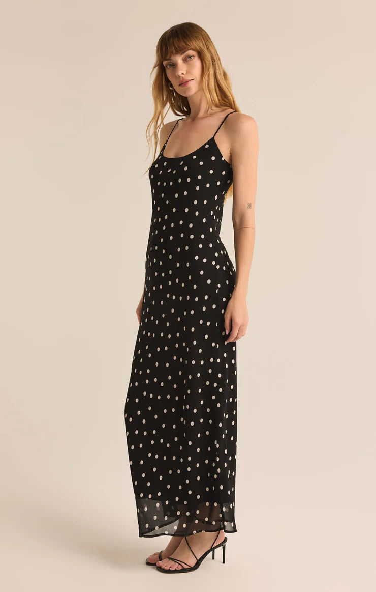 Black polka dot slip maxi dress with delicate spaghetti straps, a flowy silhouette, and a vintage-inspired design—perfect for casual or dressy occasions.