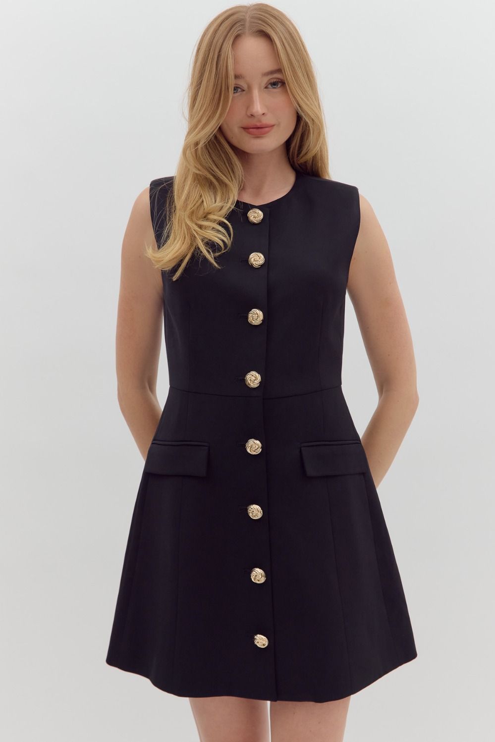 Chic sleeveless mini dress with gold buttons and flap pockets—your next game day essential.
