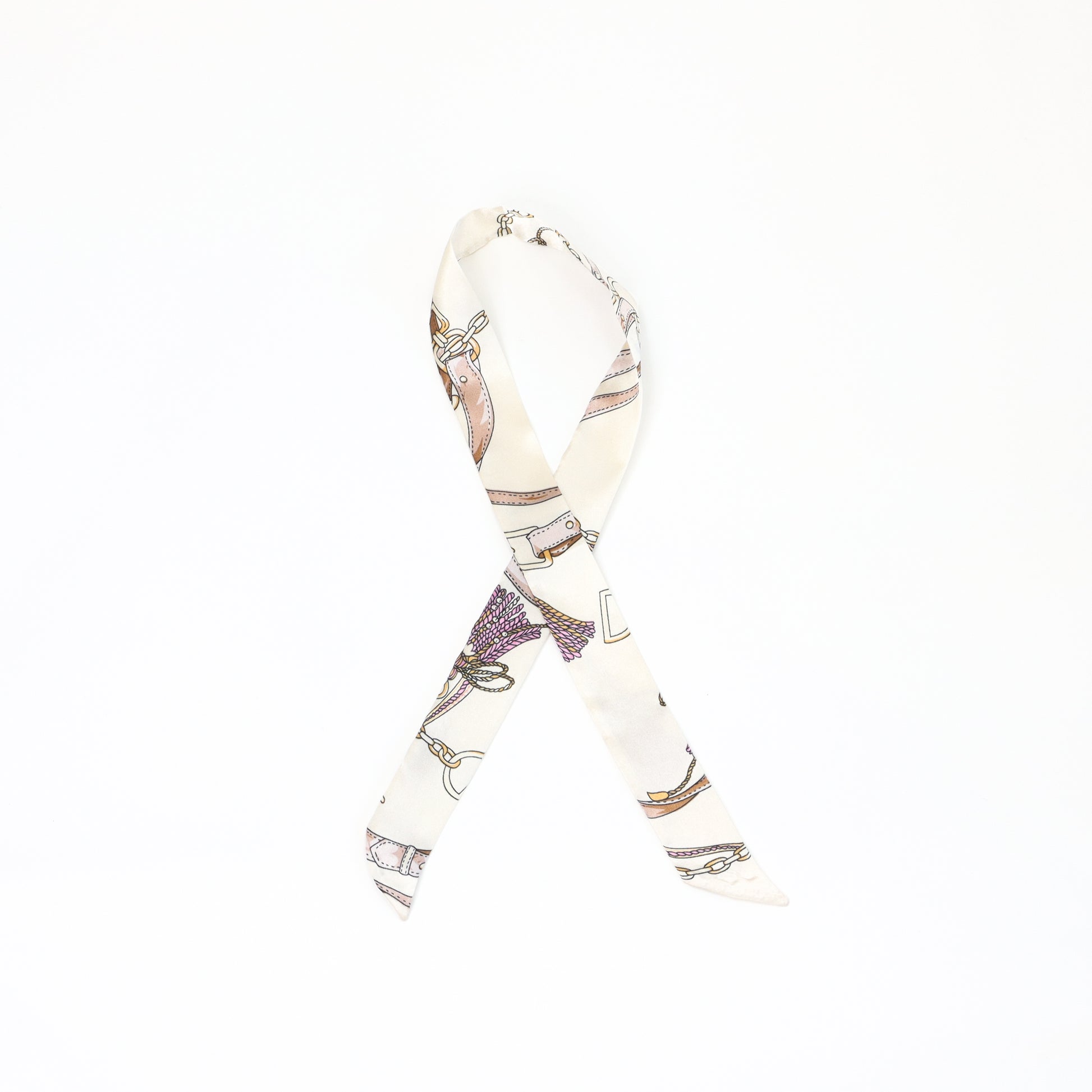  A solid cream-colored twilly scarf