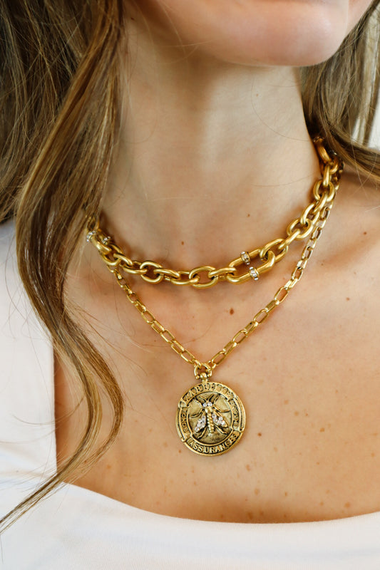  handcrafted 22K gold-plated bee medallion necklace featuring a detailed honeybee engraving with sparkling crystal accents, suspended from a chic gold link chain for a luxurious, nature-inspired look.