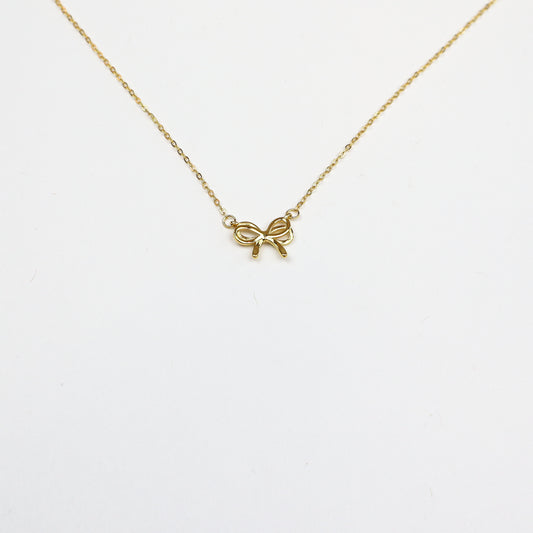 Elegant Dainty Bow Necklace featuring a delicate gold-plated bow pendant on a fine adjustable chain, perfect for minimalistic and sophisticated styling.
