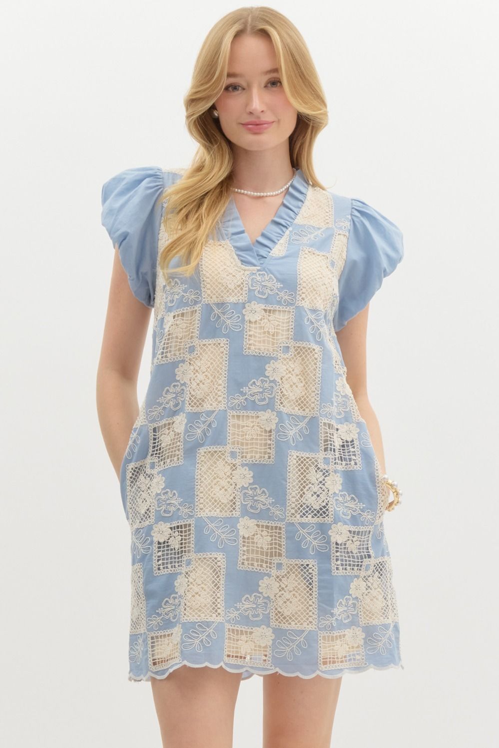 Embroidered crochet short puff bubble cap sleeve pullover mini dress. Ruffled v-neck. Pockets at side. Lined. Woven. Non-sheer. Lightweight.