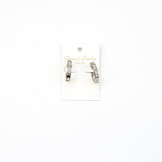 Diamond & X Hoops – Elegant silver-tone hoop earrings featuring a crisscross design with sparkling cubic zirconia stones, perfect for adding a touch of glamour.