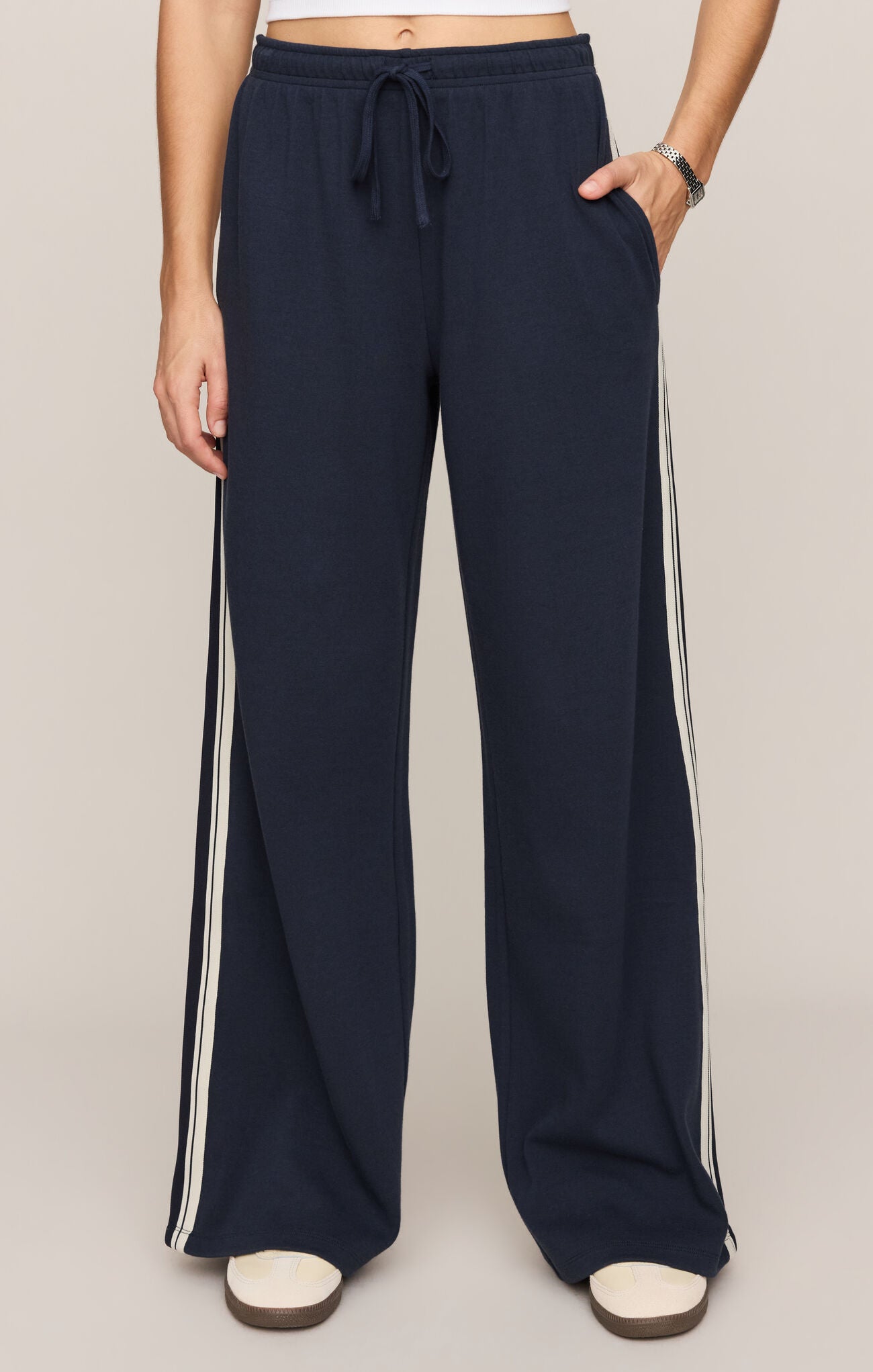 Effortlessly polished and incredibly comfortable, these high-rise knit lounge pants feature a relaxed silhouette, adjustable drawcord waist, and functional pockets for everyday versatility.