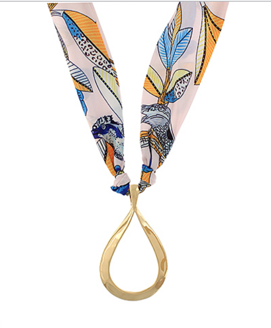 Elegant silk scarf necklace featuring a colorful floral print with a gold teardrop pendant, adding sophistication and luxury to any outfit.