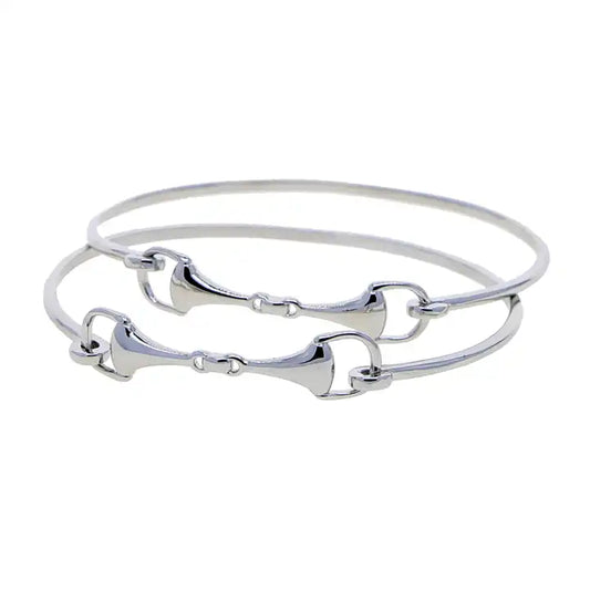 ilver snaffle bit bangle bracelets with equestrian-inspired design and polished finish.