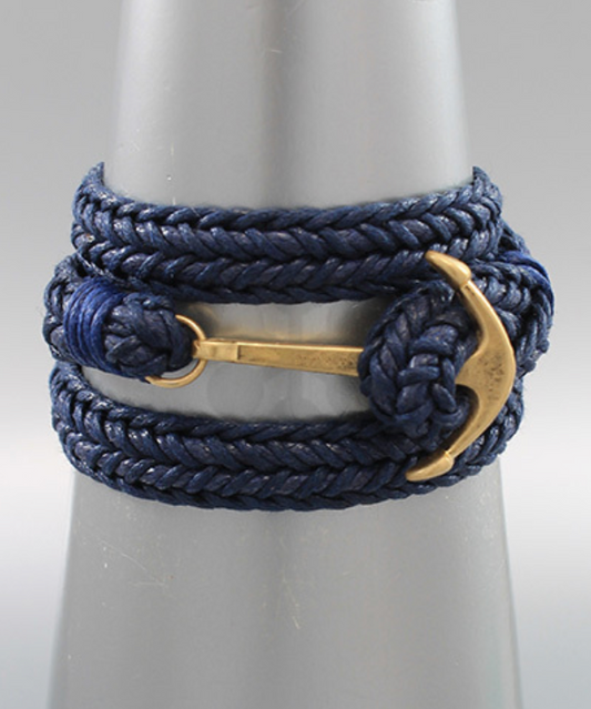 A navy blue braided rope bracelet featuring a gold-tone anchor clasp, wrapped around a wrist for a bold, maritime-inspired look.