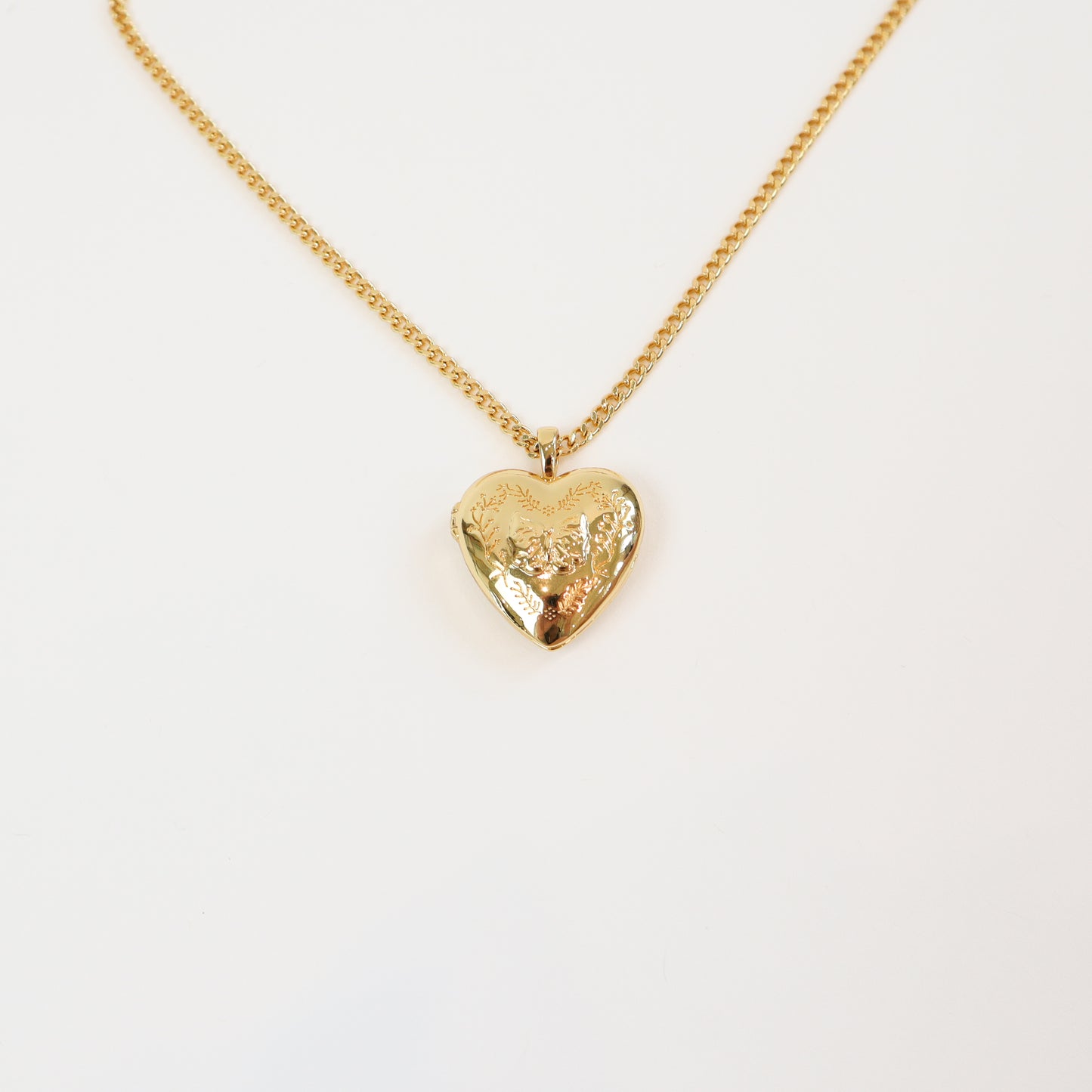 Floral Bow Locket with engraved heart pendant on a gold-tone chain