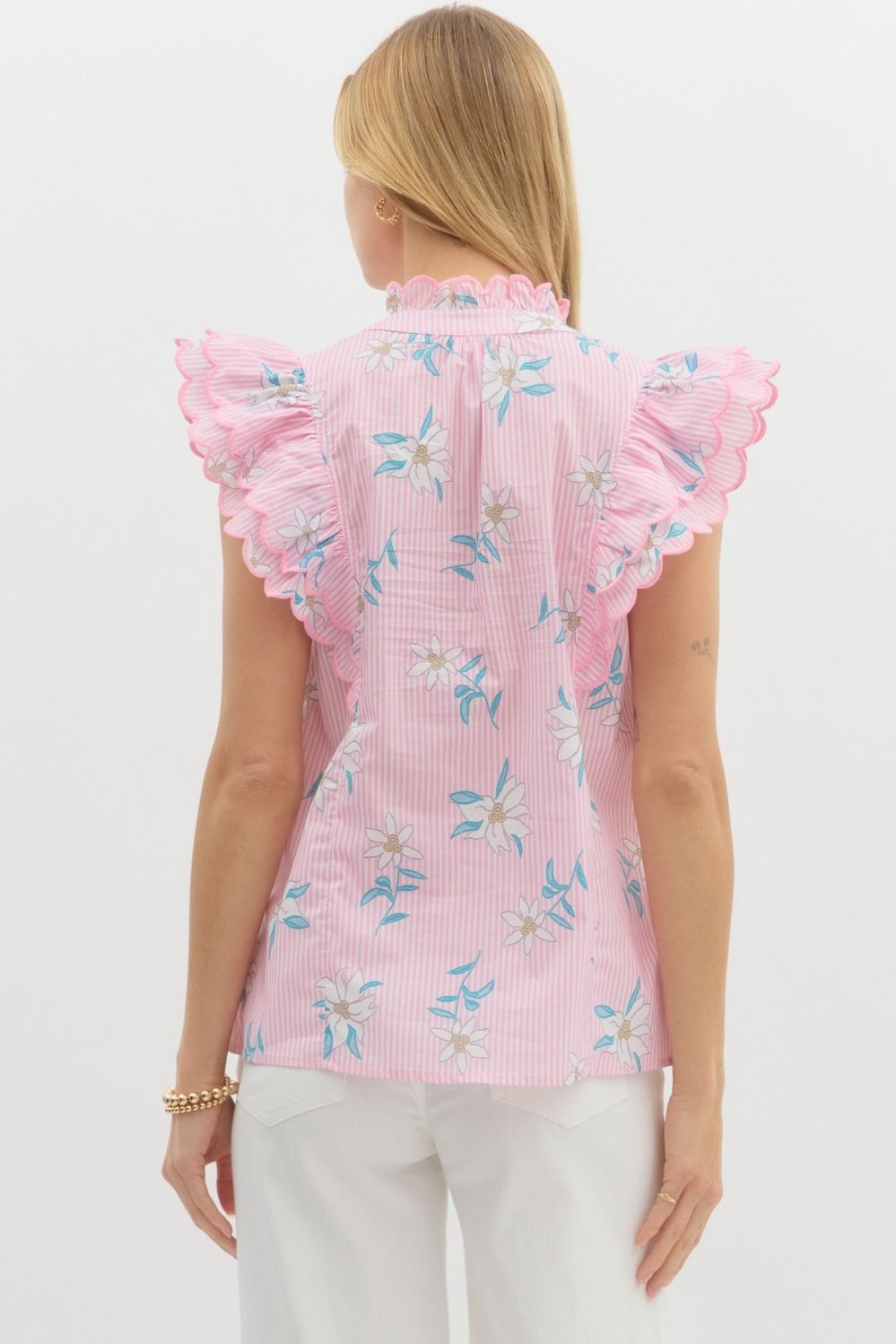 Floral striped pullover top featuring scallop embroidered edge ruffle over shoulder. Scallop edge ruffle band split collar. Unlined. Woven. Non-sheer. Lightweight.
