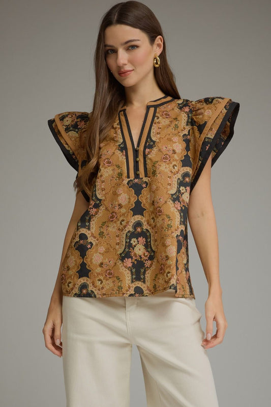 A feminine floral cotton top featuring romantic ruffle cap sleeves, contrast trim, and a flattering split neckline for effortless everyday elegance.