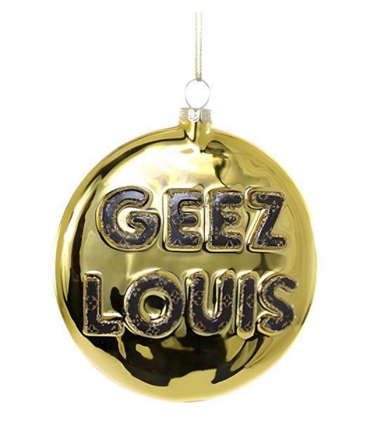 Gold Christmas ornament with bold black “Geez Louis” lettering, hanging by a gold ribbon — a fun and glamorous holiday decoration.