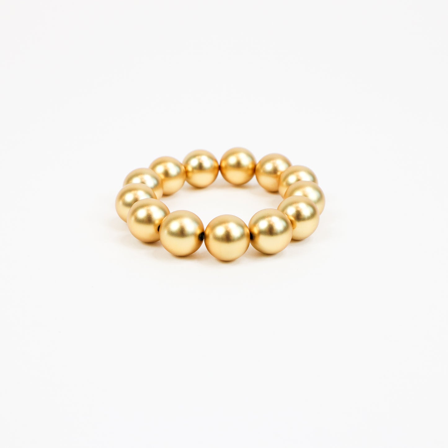 A handcrafted 22K gold-plated beaded bracelet featuring oversized polished gold beads strung together with metal accents, creating a bold yet elegant statement piece.