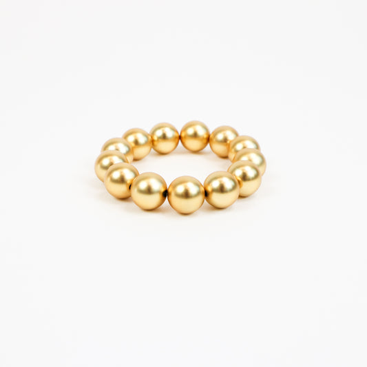 A handcrafted 22K gold-plated beaded bracelet featuring oversized polished gold beads strung together with metal accents, creating a bold yet elegant statement piece.