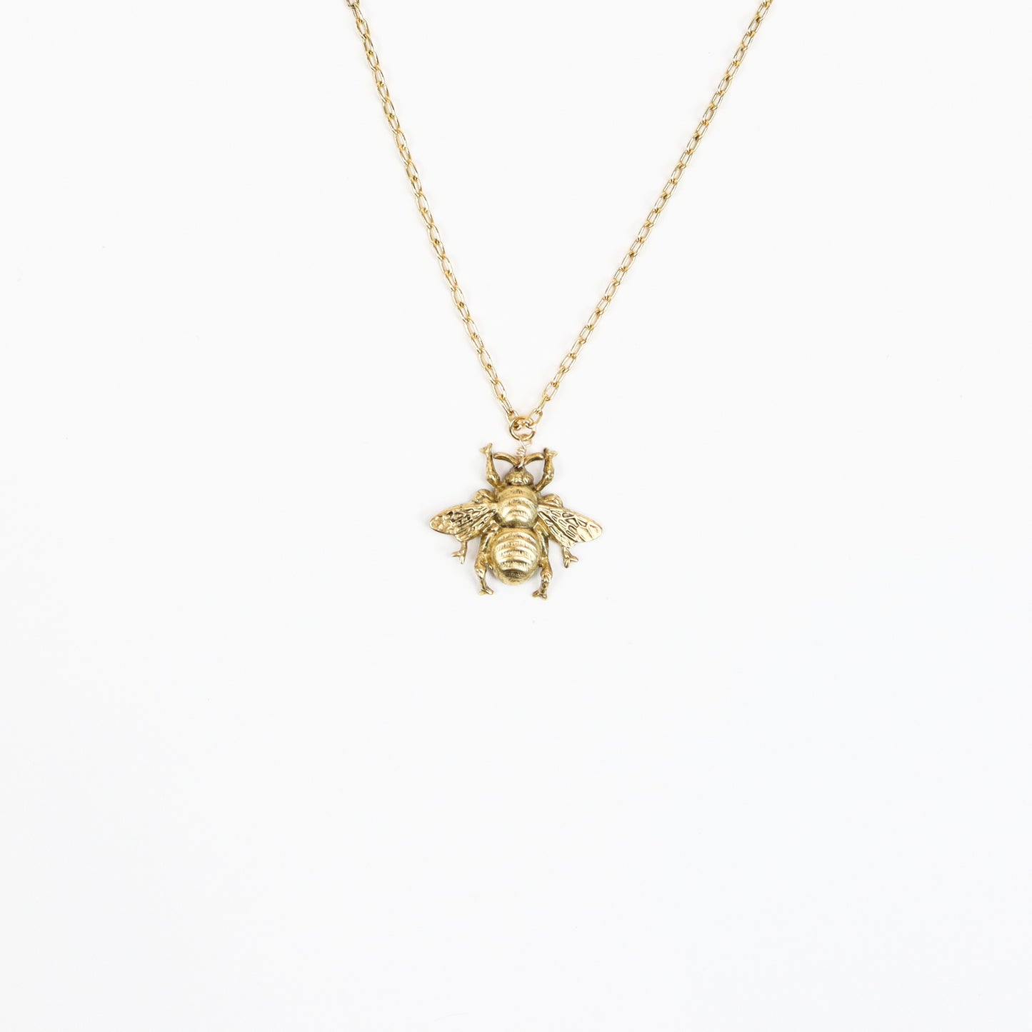  A handcrafted 22K gold-plated honeybee pendant necklace featuring intricate wing and body details, suspended on a delicate gold chain, embodying elegance and nature-inspired beauty.
