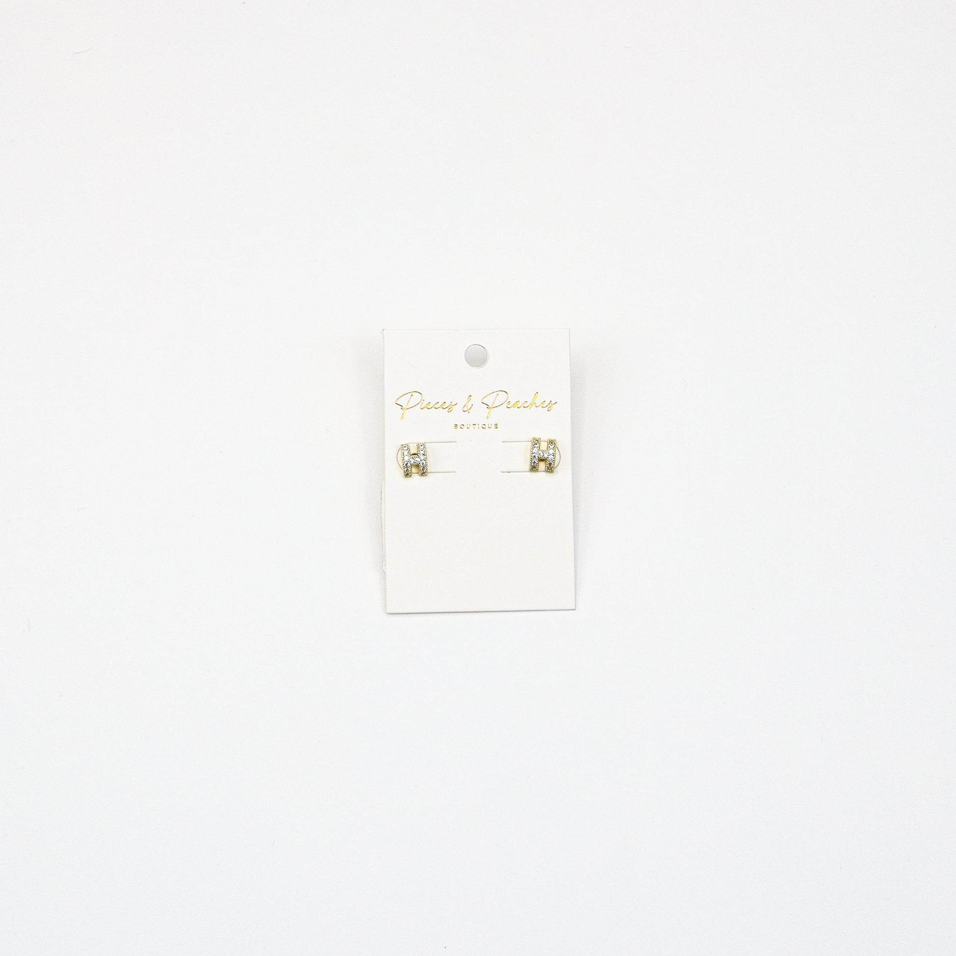 Gold H-shaped stud earrings with cubic zirconia accents, featuring a minimalist yet elegant design for everyday wear